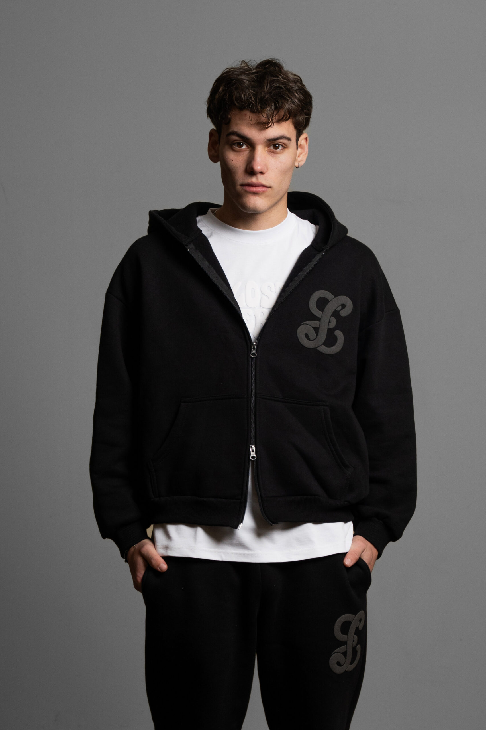black zip up worn by model